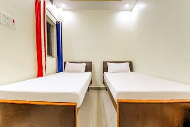 Multi-bed room at Happy Guest House Bodhgaya arranged with two beds for families or small groups